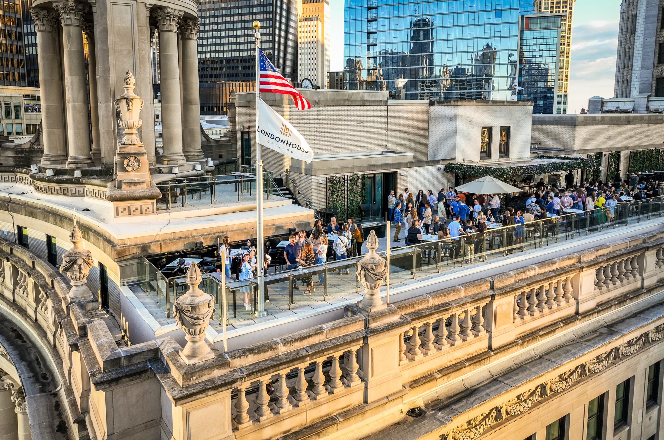 A company gathering on a downtown rooftop at golden hour